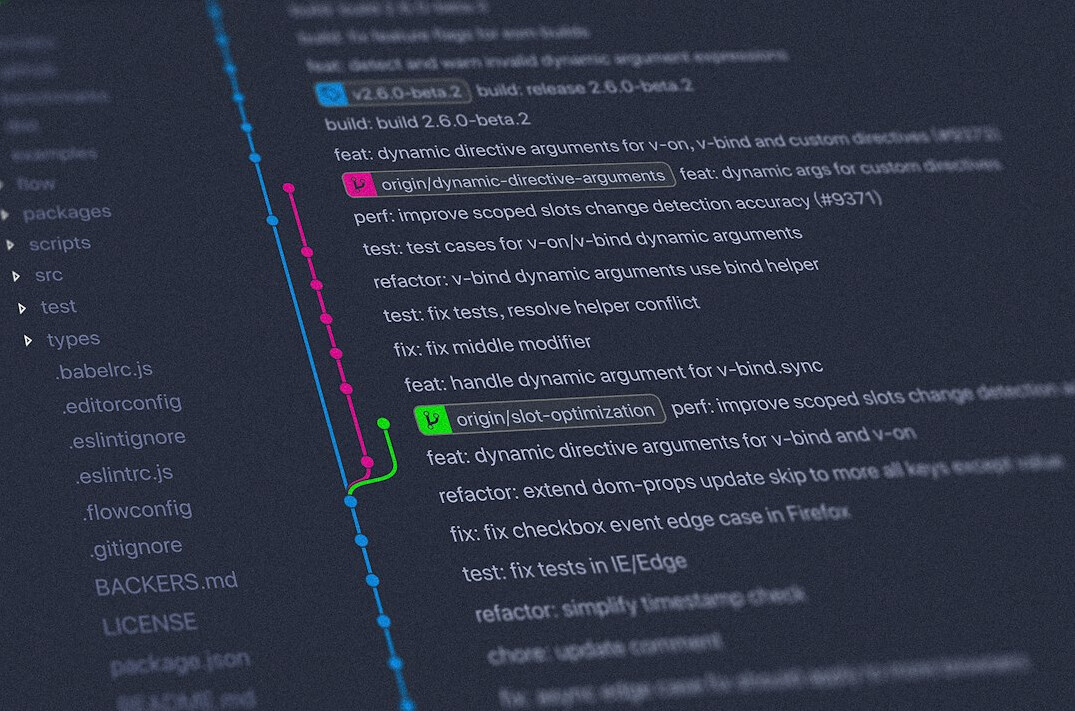 Small team of developers of mixed Croatian ethnicity collaborating around a laptop in an office